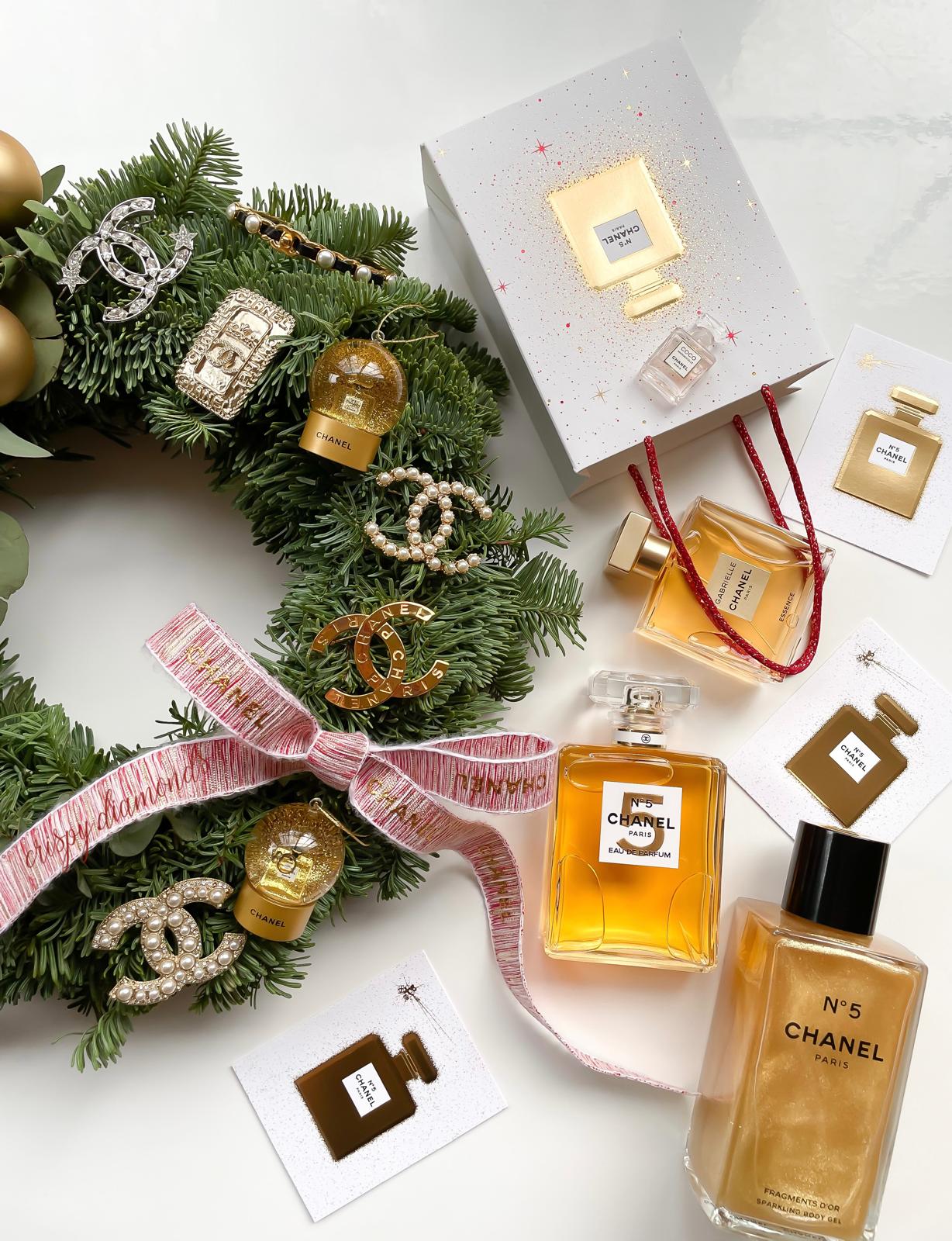 Chanel N5 Christmas wreath with gold jewelry, pearl brooches, and luxury holiday decor